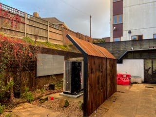 Air source heat pump and noise barrier