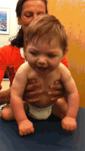 A woman playing with baby Carter