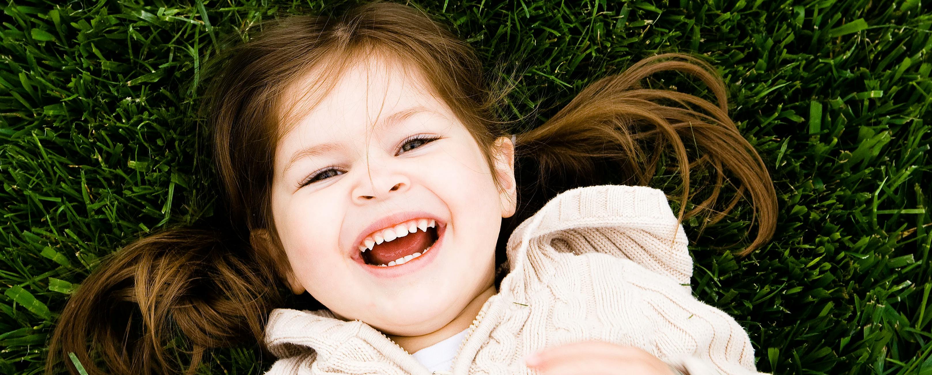 Girl smiling lying in the grass