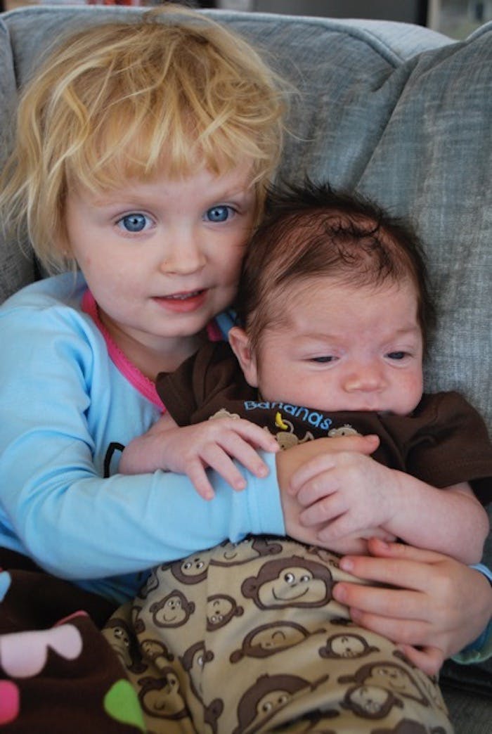 Baby Carter being hugged by his big sister