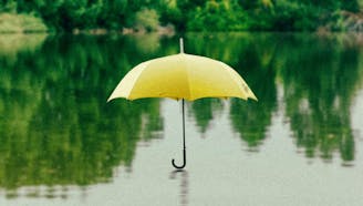 floating yellow umbrella in a lake