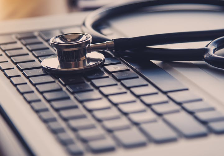 Stethoscope sitting on a keyboard