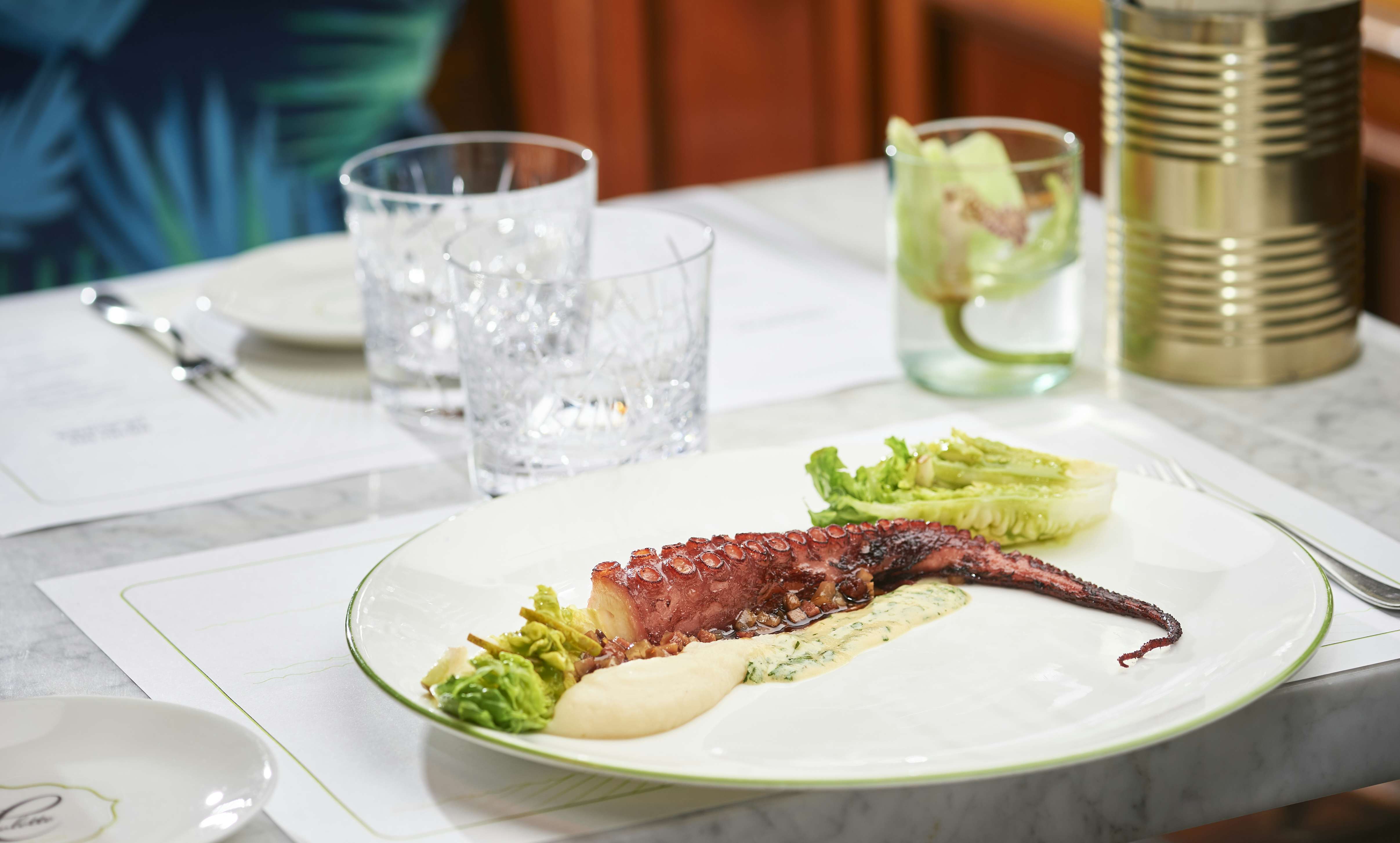 Plate with pulpo on set marble table