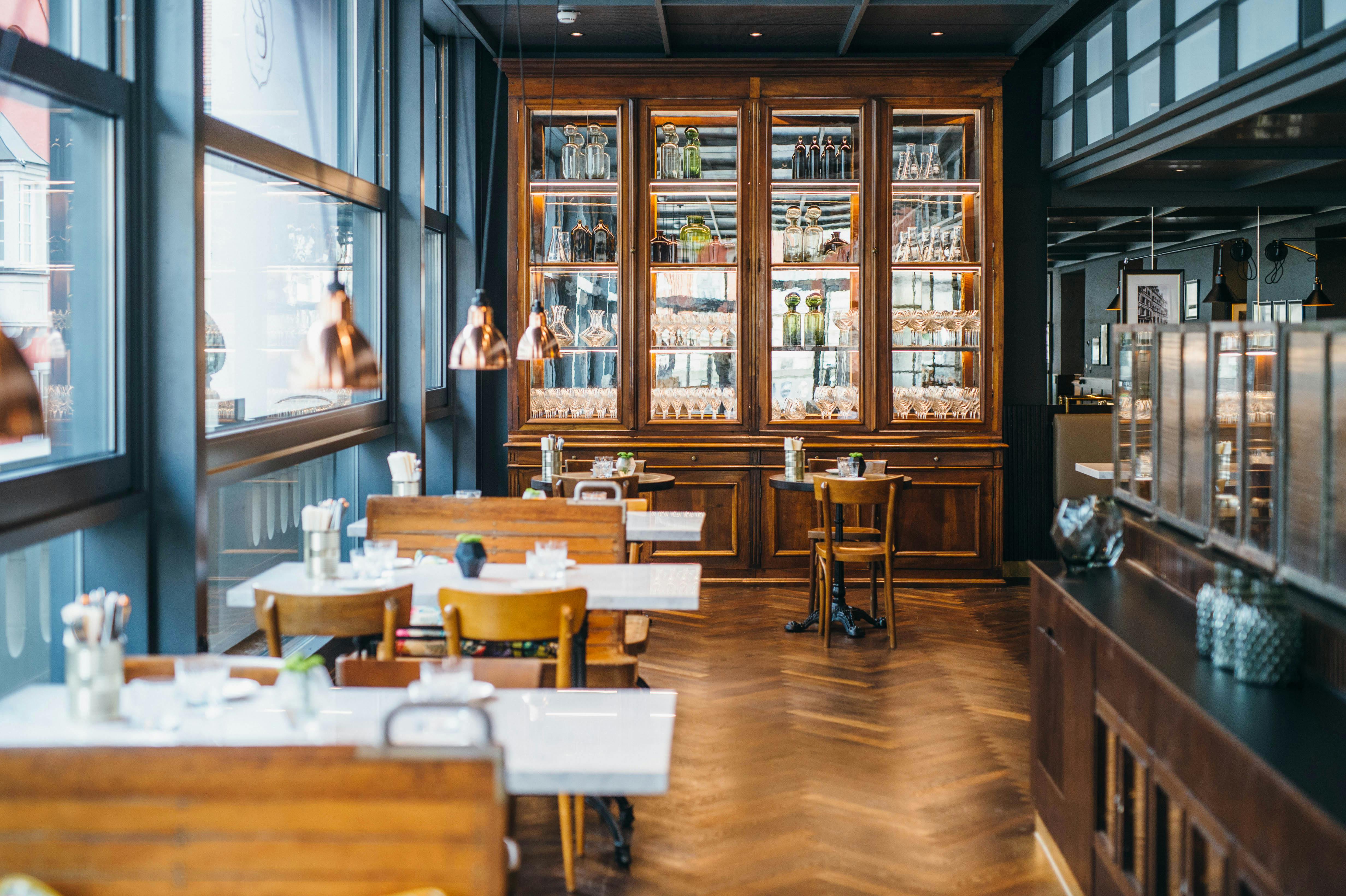 Gedeckte Tische und Apothekerschrank in der Brasserie Colette Konstanz