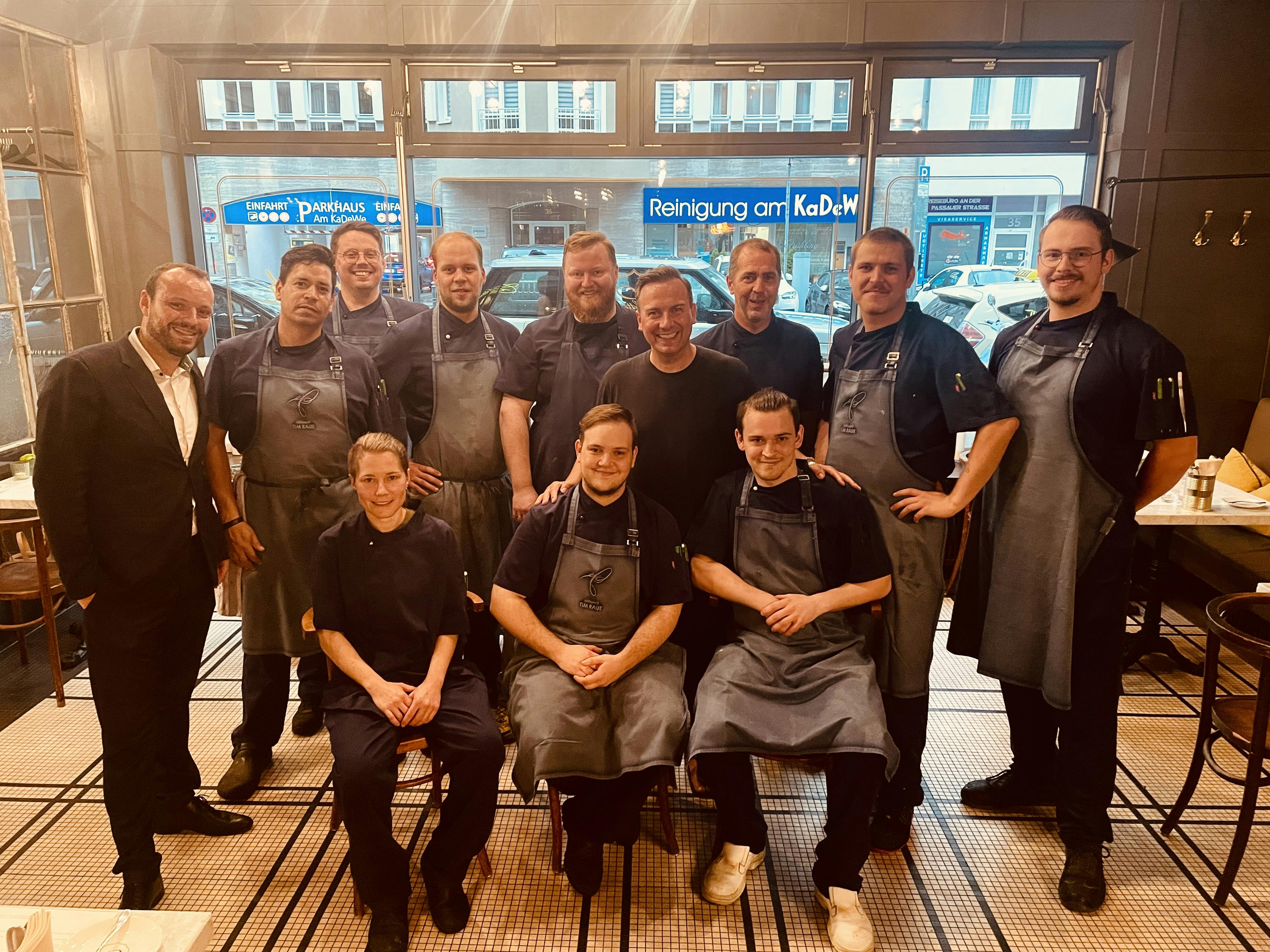 Das Team der Brasserie Colette Berlin im Gastraum mit Tim Raue.