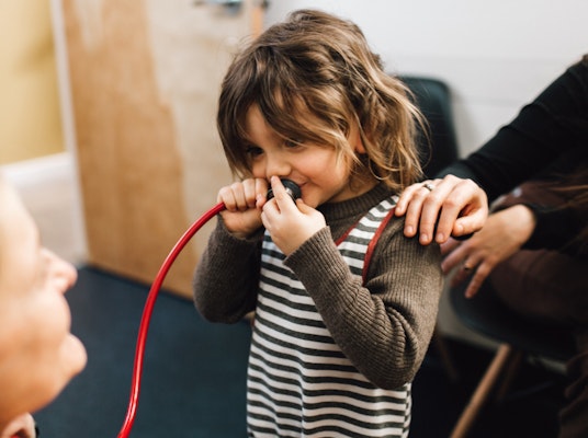 Child holding a stethoscope