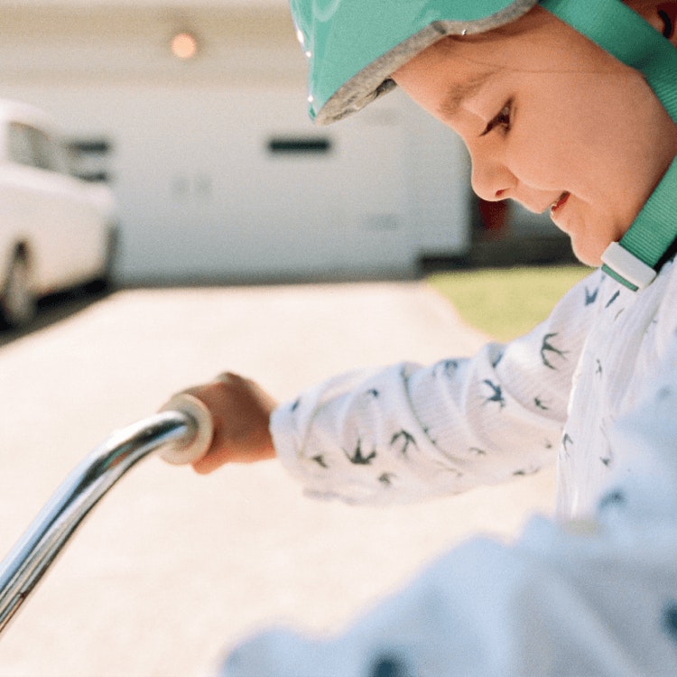 Child wearing helmet while riding a bike