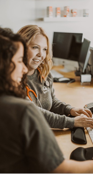 Brave Care’s medical providers looking at computer screen