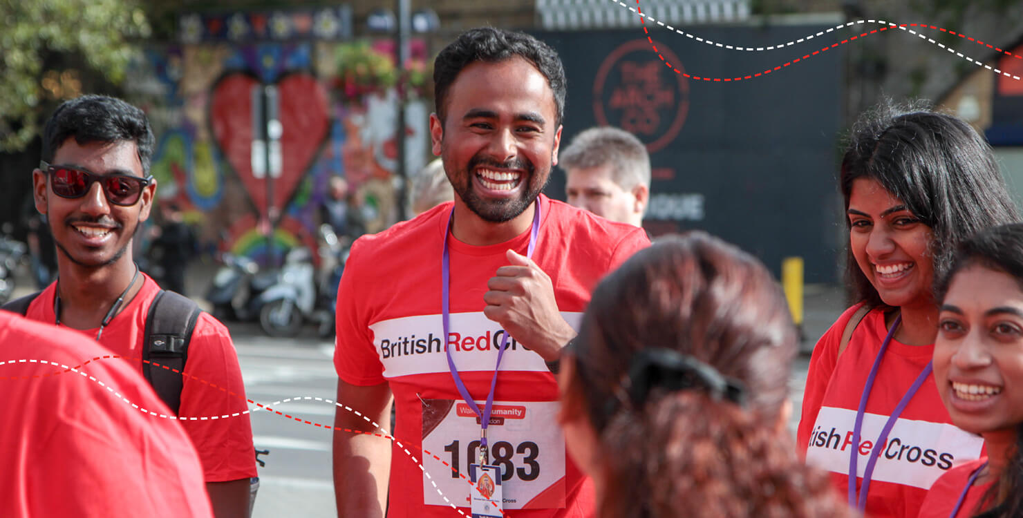 A group of Walk for Humanity participants laugh and chat at event.