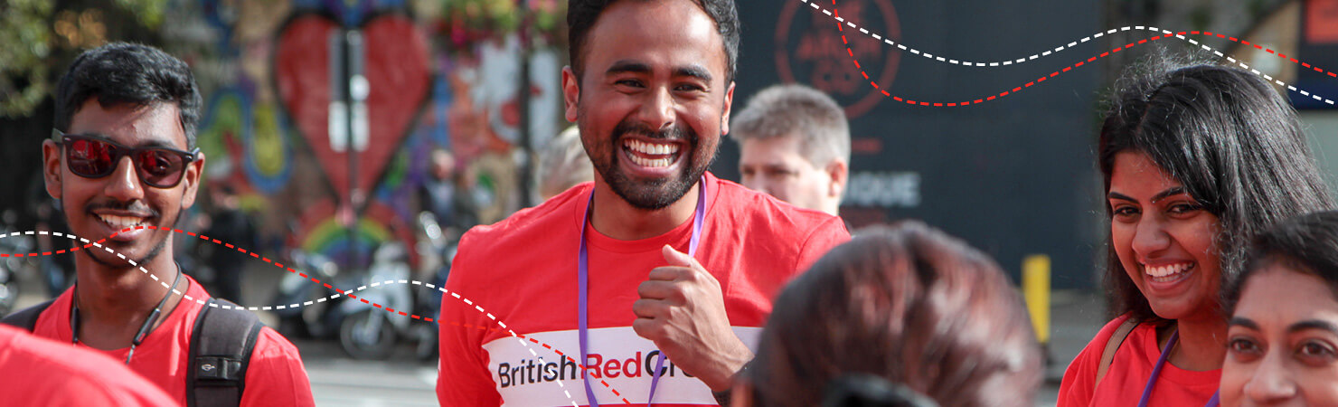 A group of Walk for Humanity participants laugh and chat at event.