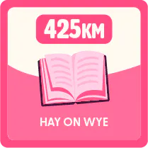 Illustration of a book with two labels, reading ‘425 km’ above it, indicating distance, and ‘Hay on Wye’ below.