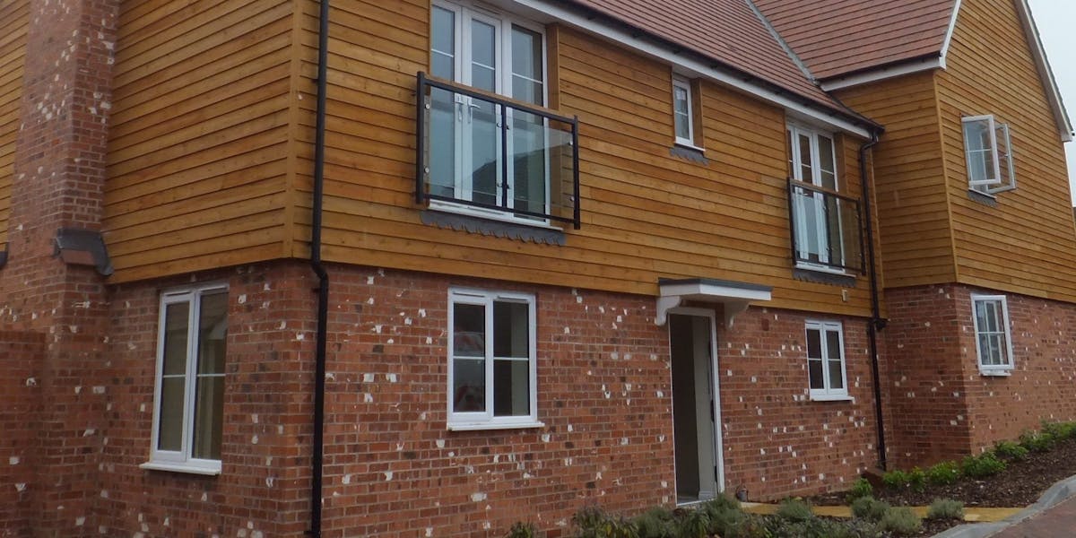 A large detached dwelling clad in timber and brick slips