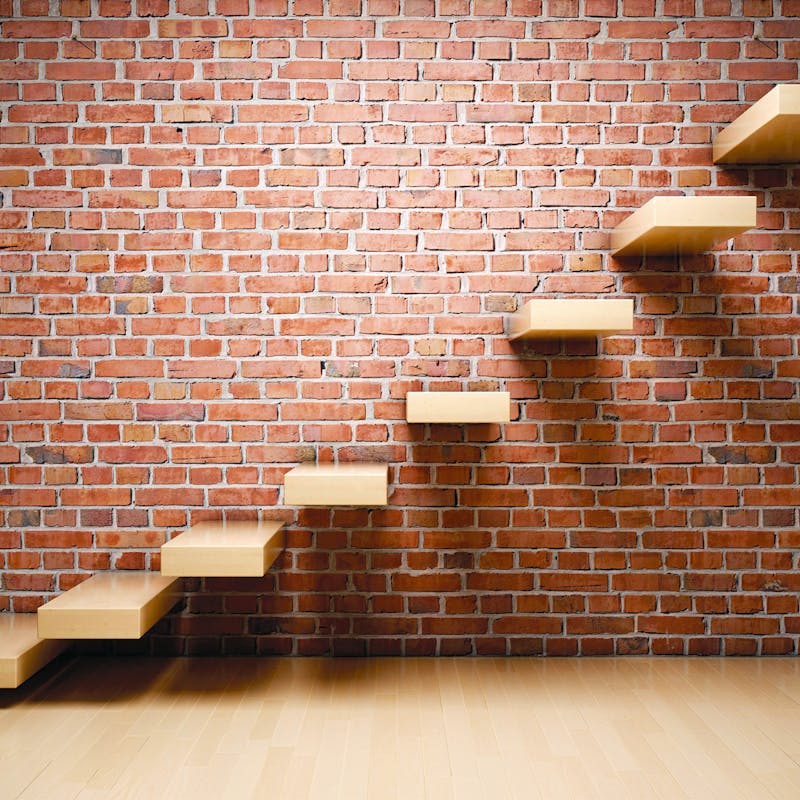 Wild Stone Brick Veneer behind an internal open-tread staircase