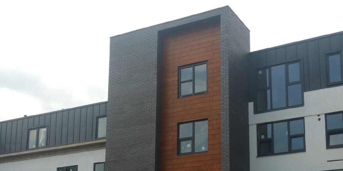 Candiwall brick cladding in use on an apartment block exterior lift shaft.