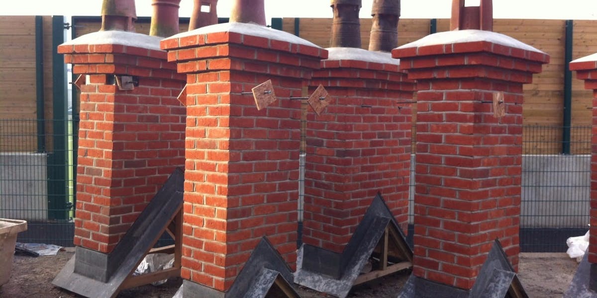 Pre-fabricated chimneys standing in a builders yard