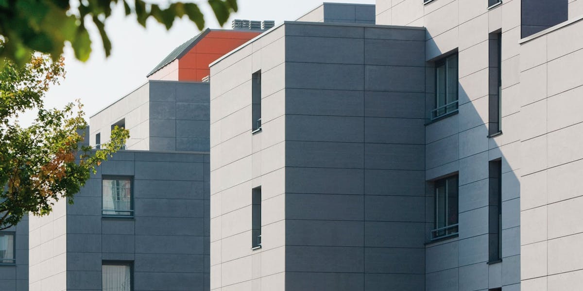 An apartment complex clad in modern grey rain screen cladding