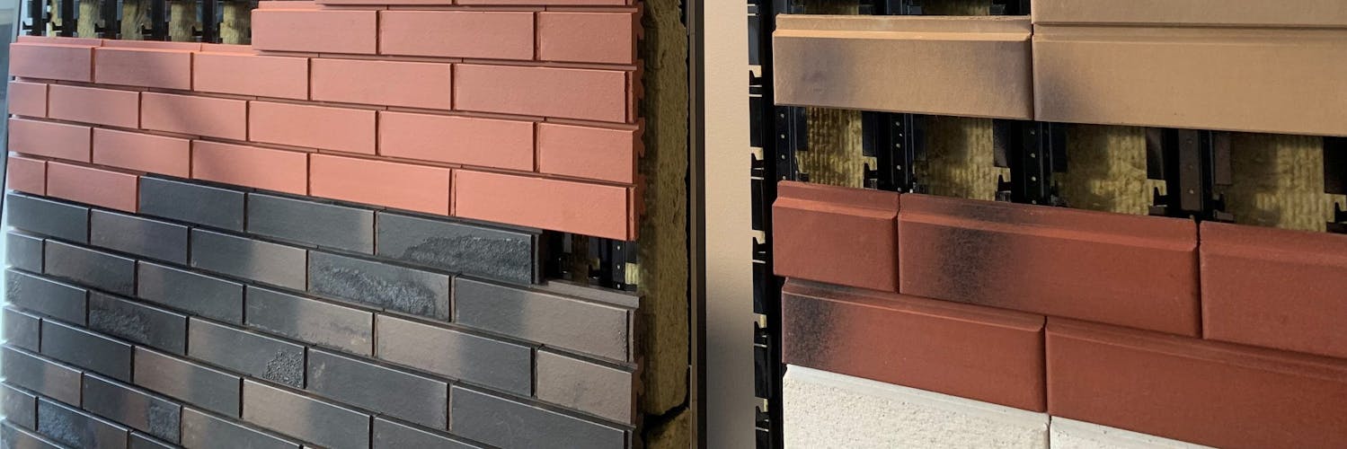 A wall mounted display stand showing the SCANROC ventilated facade system
