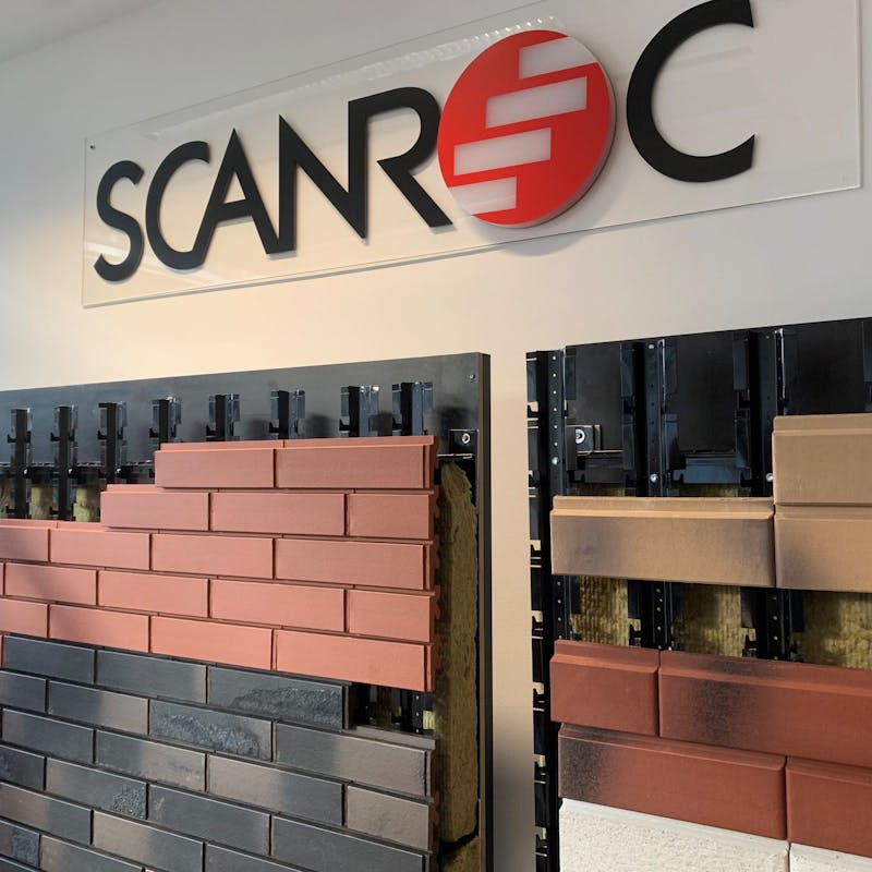 A wall mounted display stand showing the SCANROC ventilated facade system