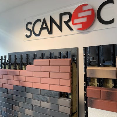 A wall mounted display stand showing the SCANROC ventilated facade system