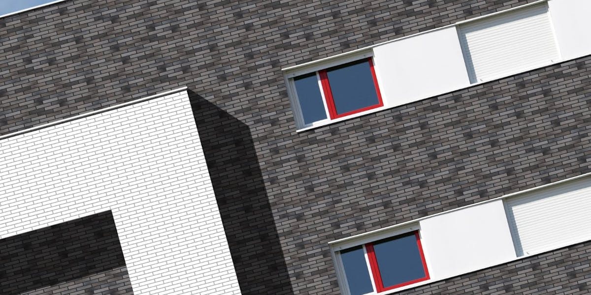 Omega bricks on a large building - Mountain Grey colour