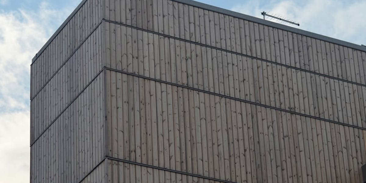 A building clad in Thermowood that has weathered to grey