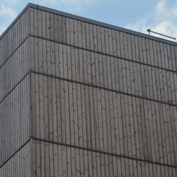 A building clad in Thermowood that has weathered to grey