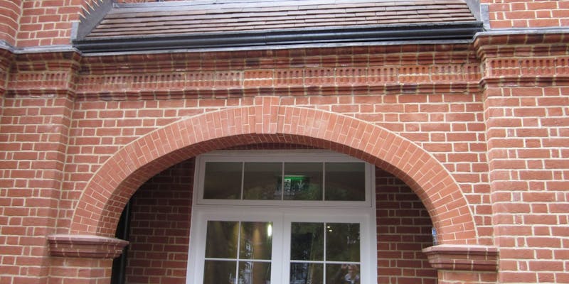 A pre-fabricated structural brick archway over an entrance vestibule