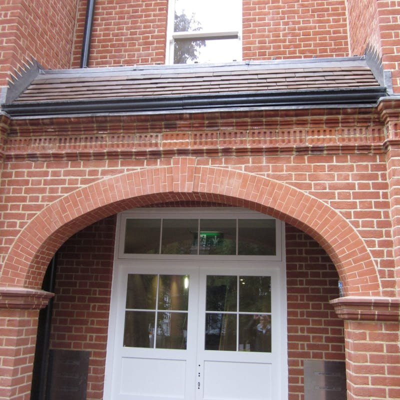 A pre-fabricated structural brick archway over an entrance vestibule