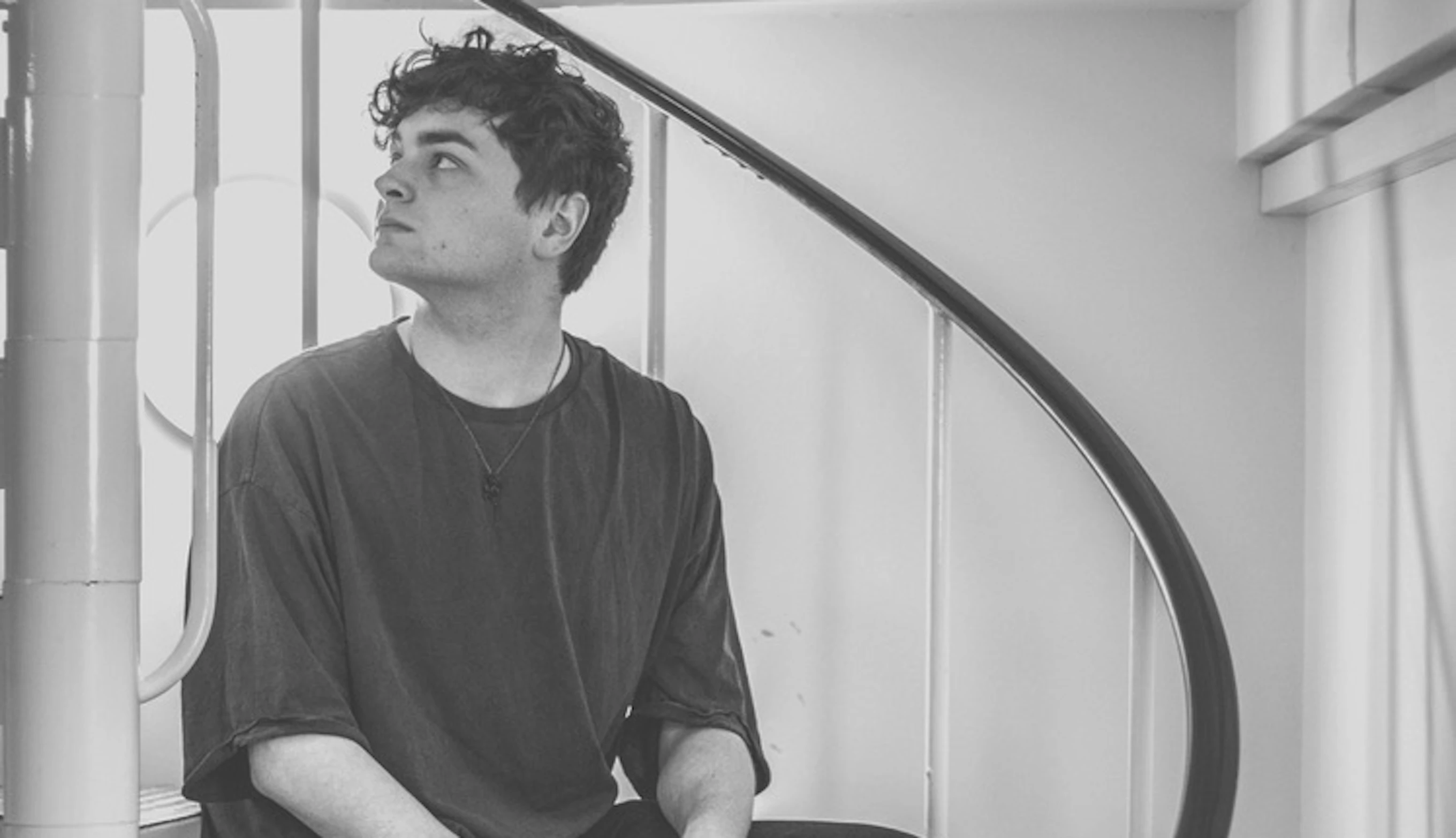 Joel Foster sat at the bottom of a set of winding steps, looking up.