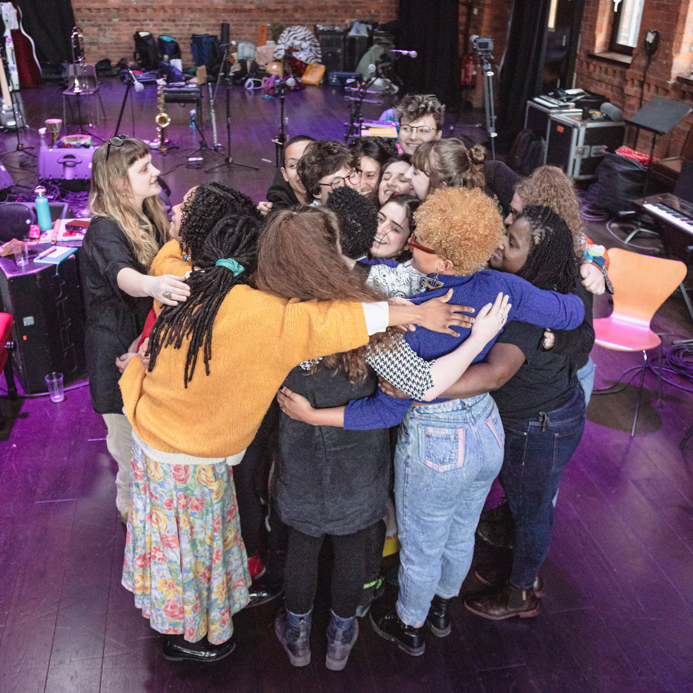 Nubya Garcia and the residency participants in a group huddle.