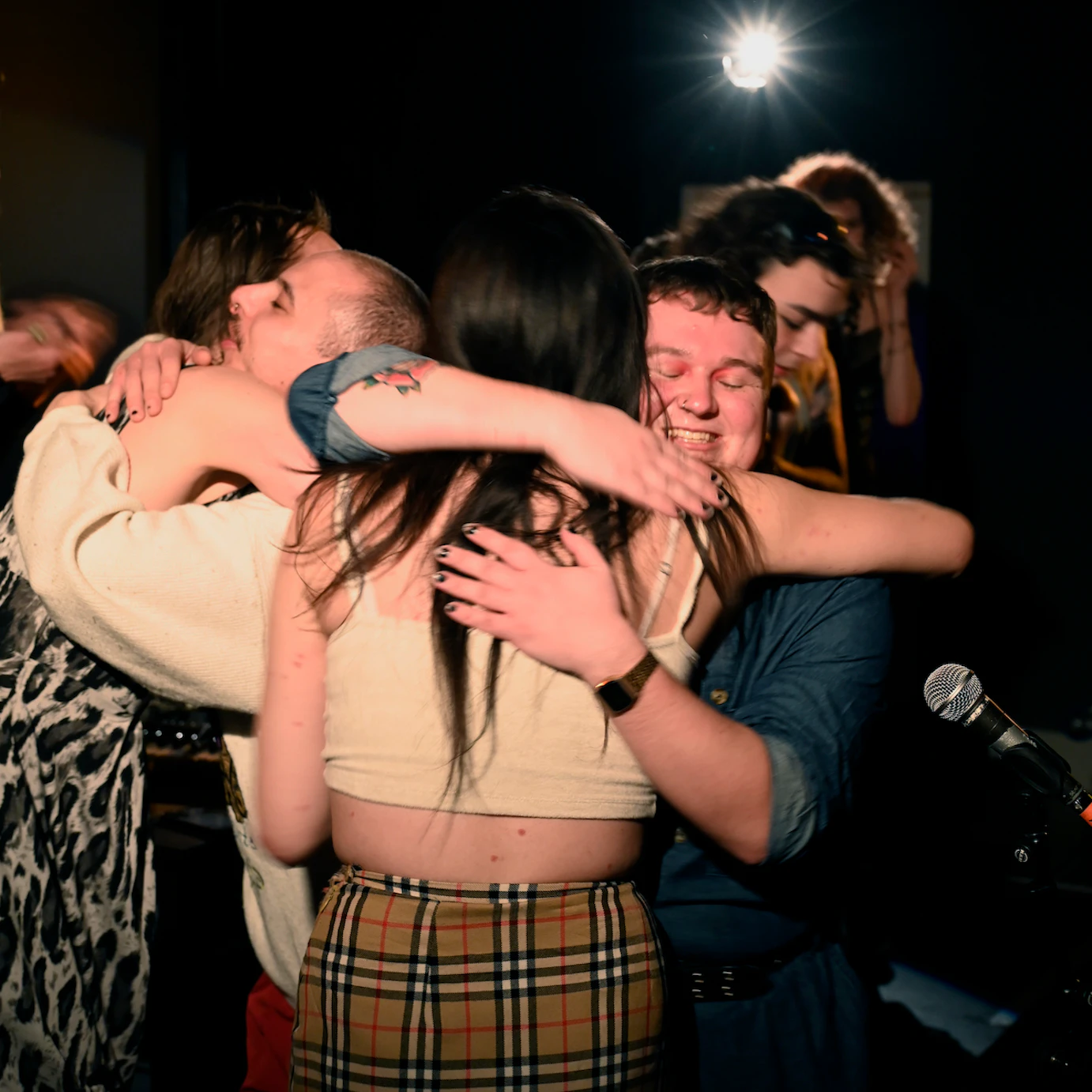 Residency artists hugging at the end of the show.