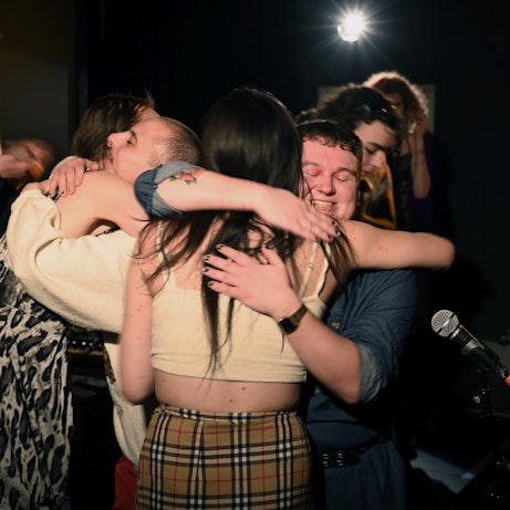 Residency artists hugging at the end of the show.
