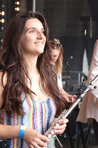 Caroline Webb holding a flute smiling off into the distance.