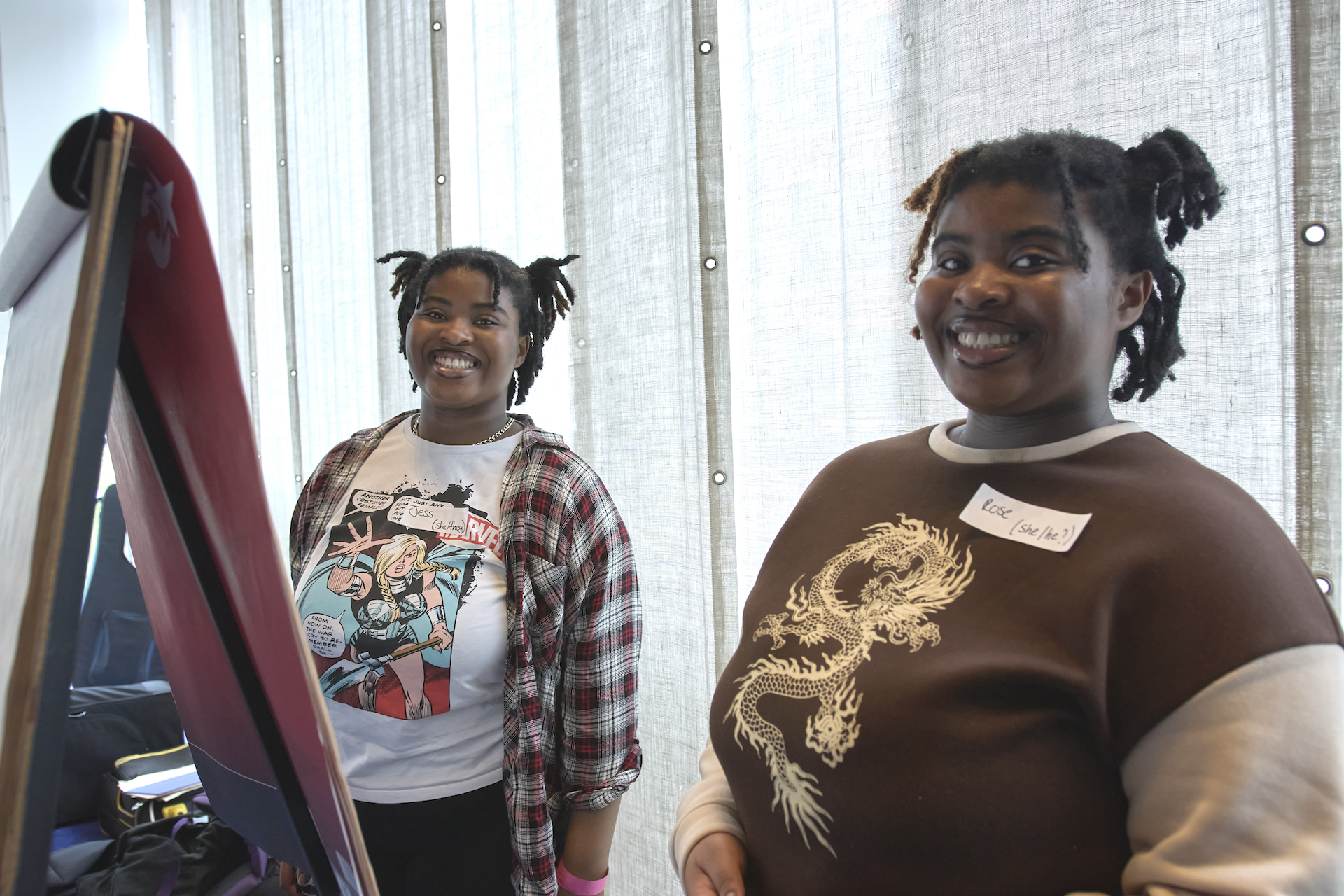 Two young musicians smiling to the camera.