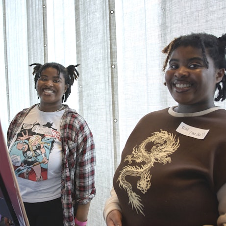 Two young musicians smiling to the camera.