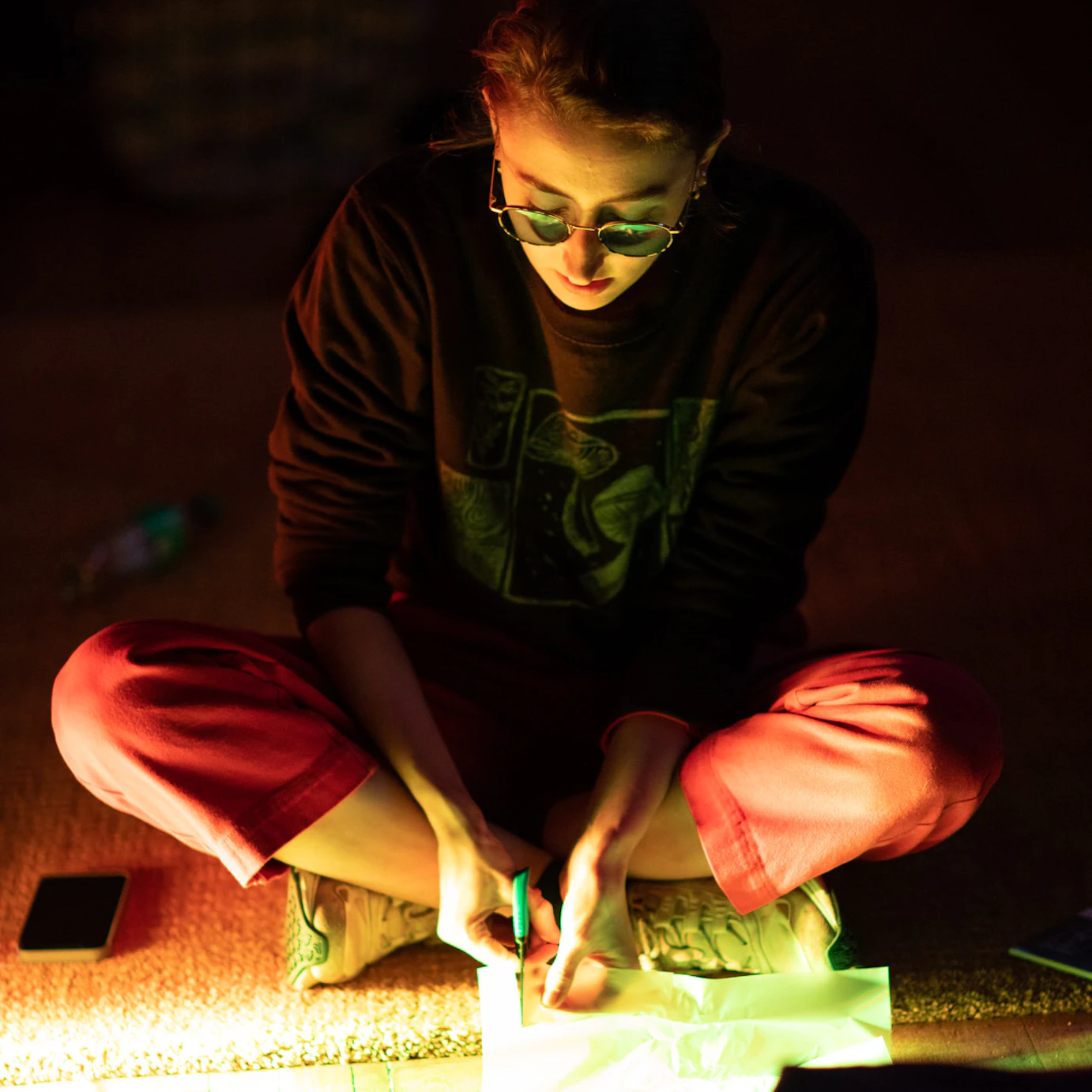Rosie Woolaghan cutting into paper during the residency week at Self, Sense, Space.
