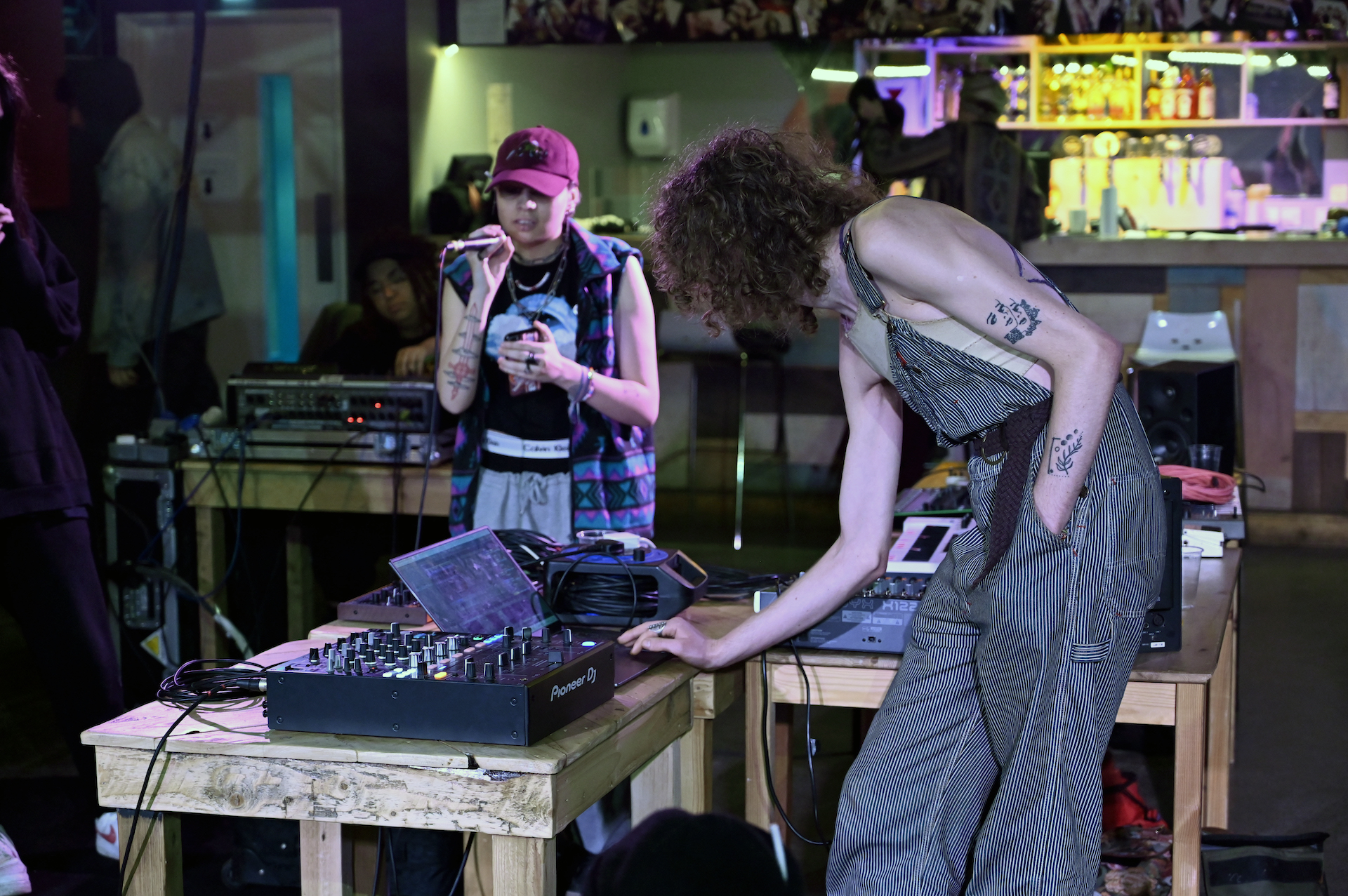 Residency artists rehearsing their music with microphones and laptops.