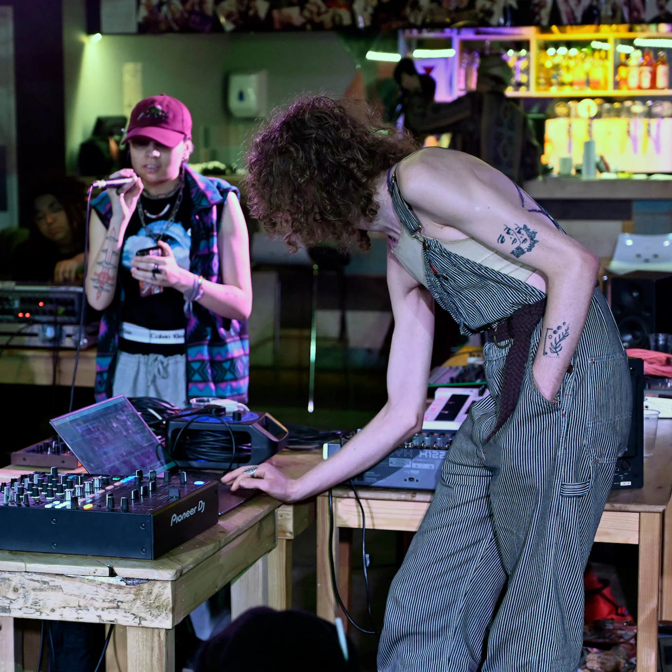 Residency artists rehearsing their music with microphones and laptops.