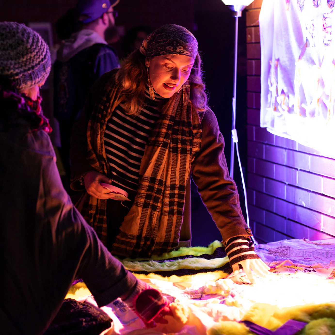 Audience members touching a fabric blanket created as part of Self, Sense, Space.