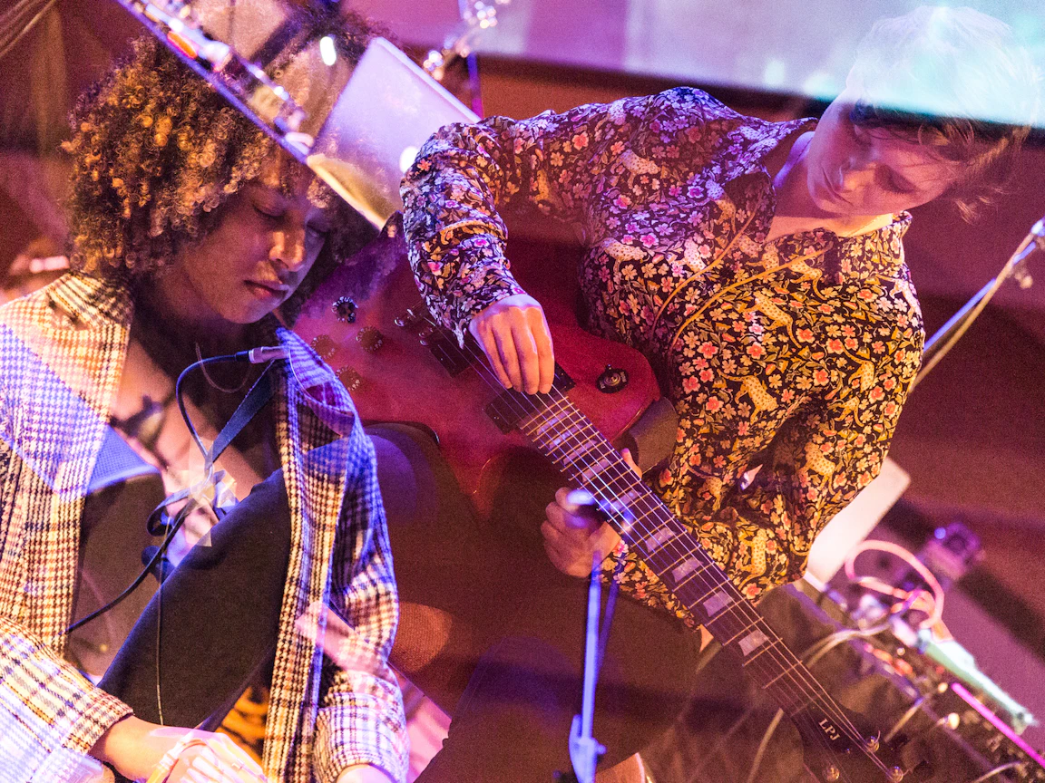 Two participants of Electric Storm playing instruments. The filter on the image overlaps the two of them.