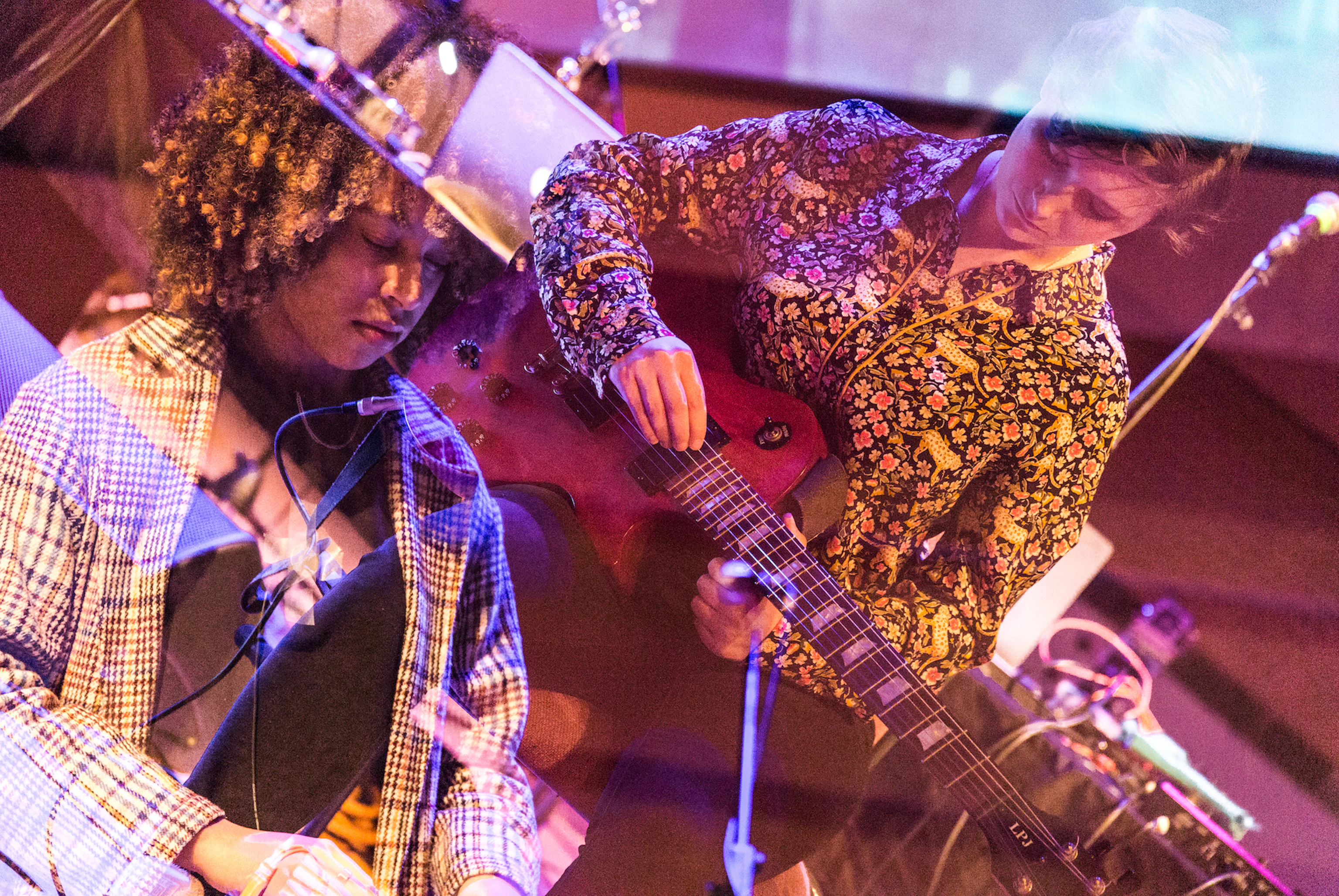 Two participants of Electric Storm playing instruments. The filter on the image overlaps the two of them.