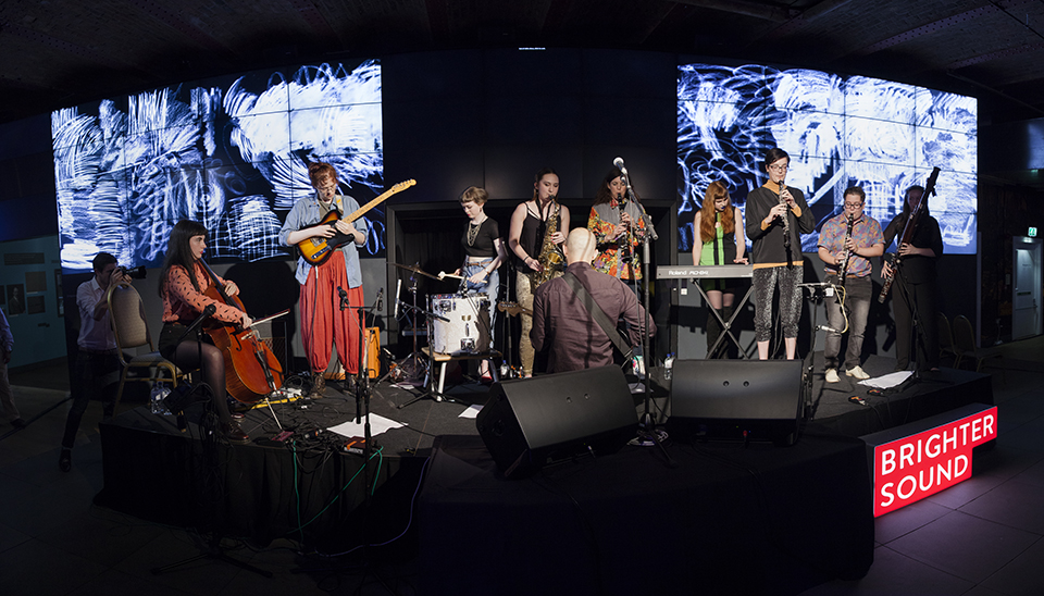 Musicians performing on stage with Anna Meredith.