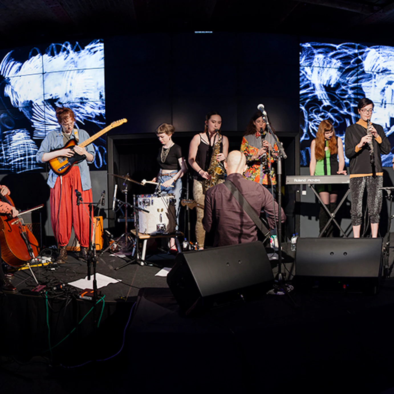 Musicians performing on stage with Anna Meredith.
