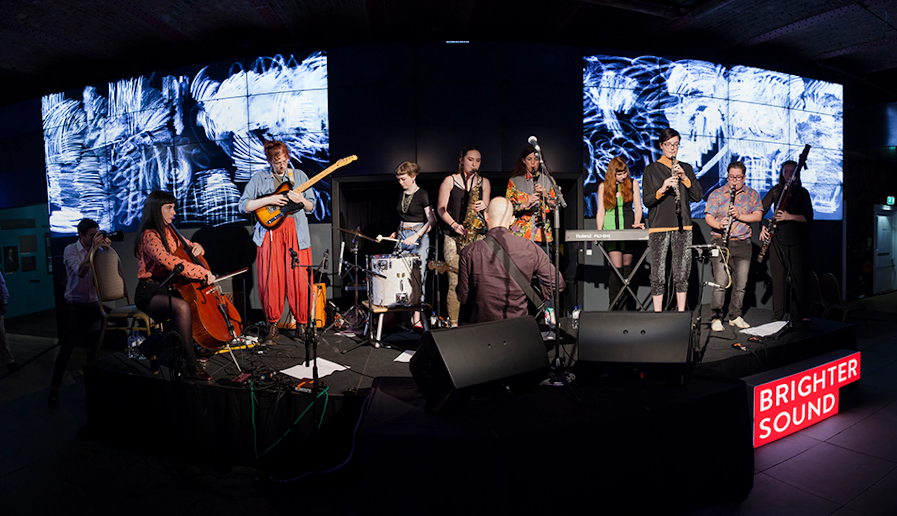 Musicians performing on stage with Anna Meredith.