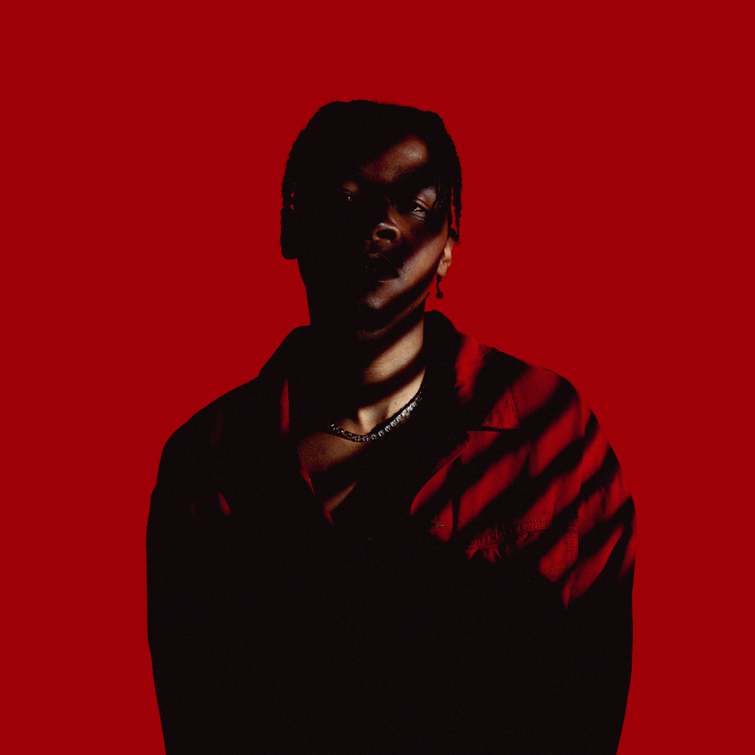 PRIDO stood in lined shadows on a red background.