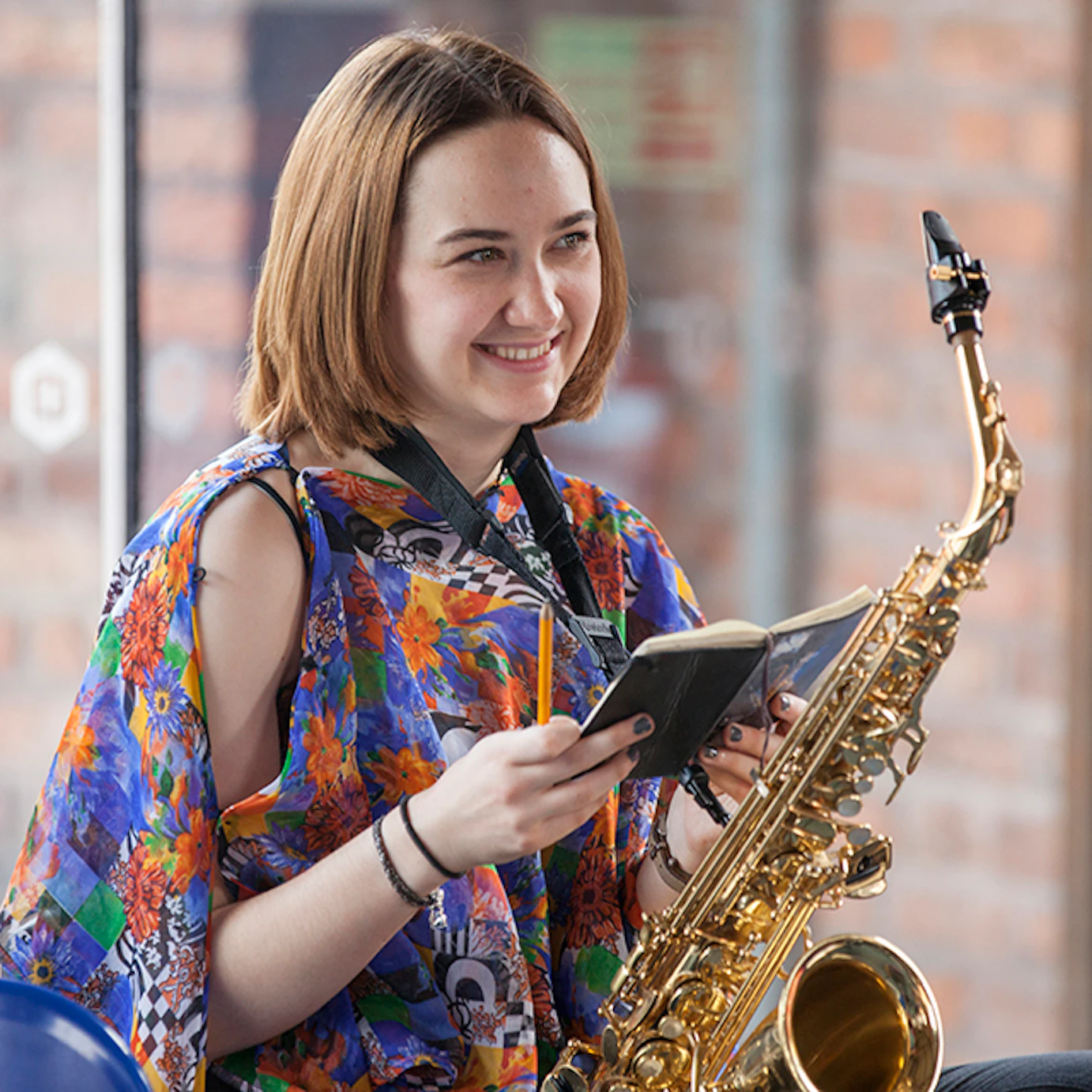 A saxophonist with a notebook.