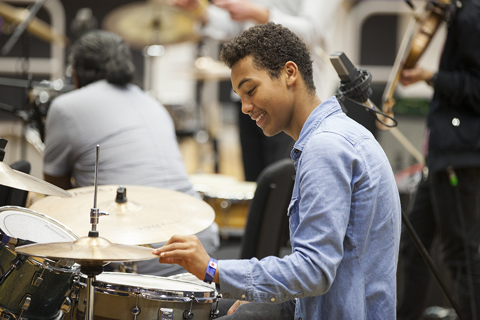 A drummer smiling.