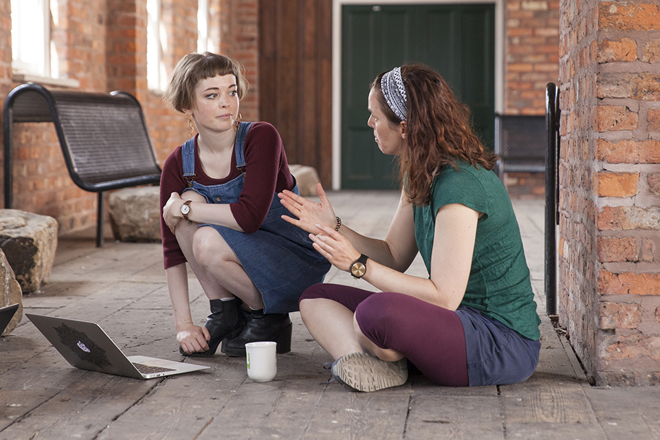 Anna Meredith chatting with a musician.