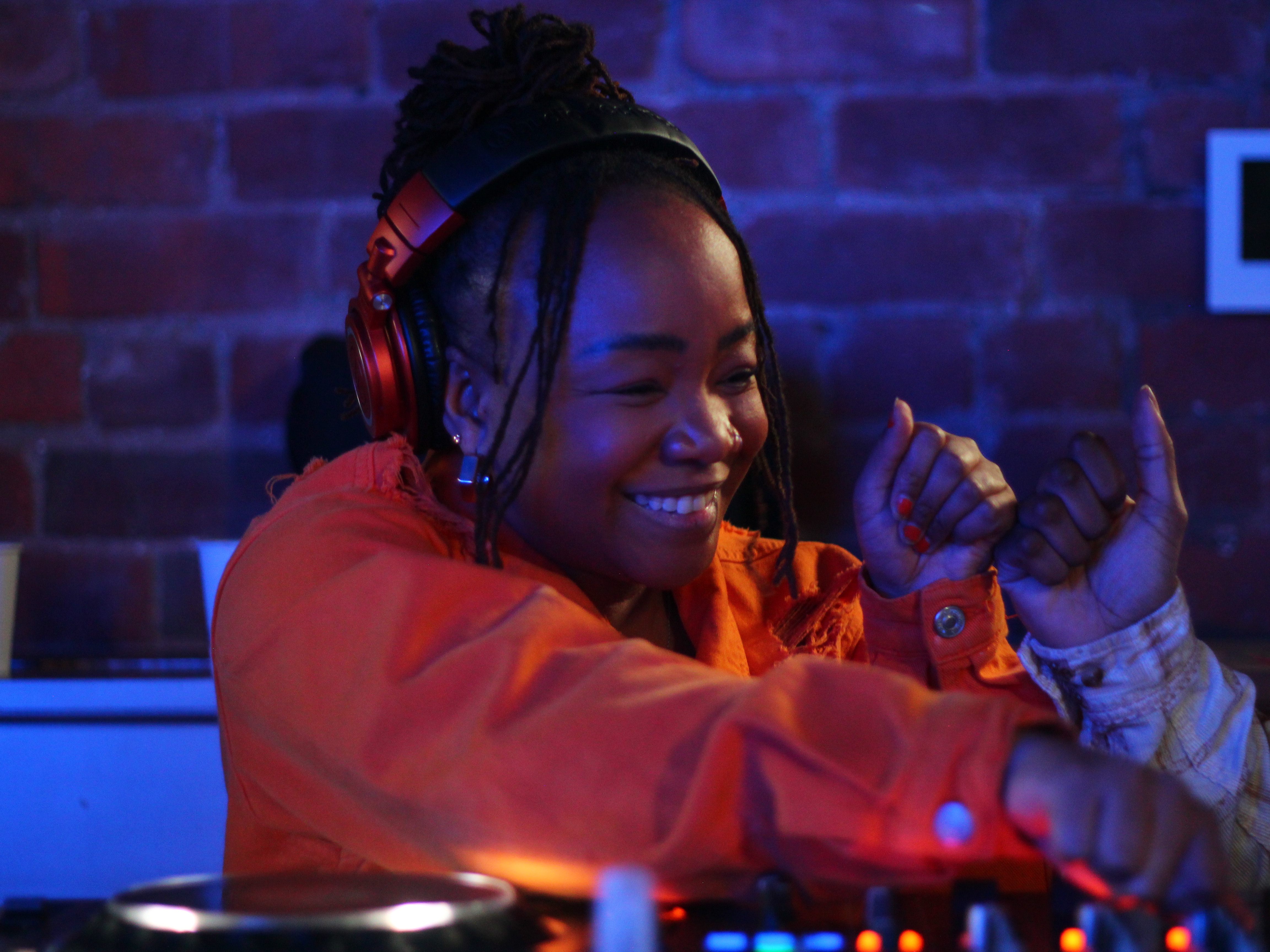 An Afro Energy participant smiling and fist bumping on the decks during the listening party.