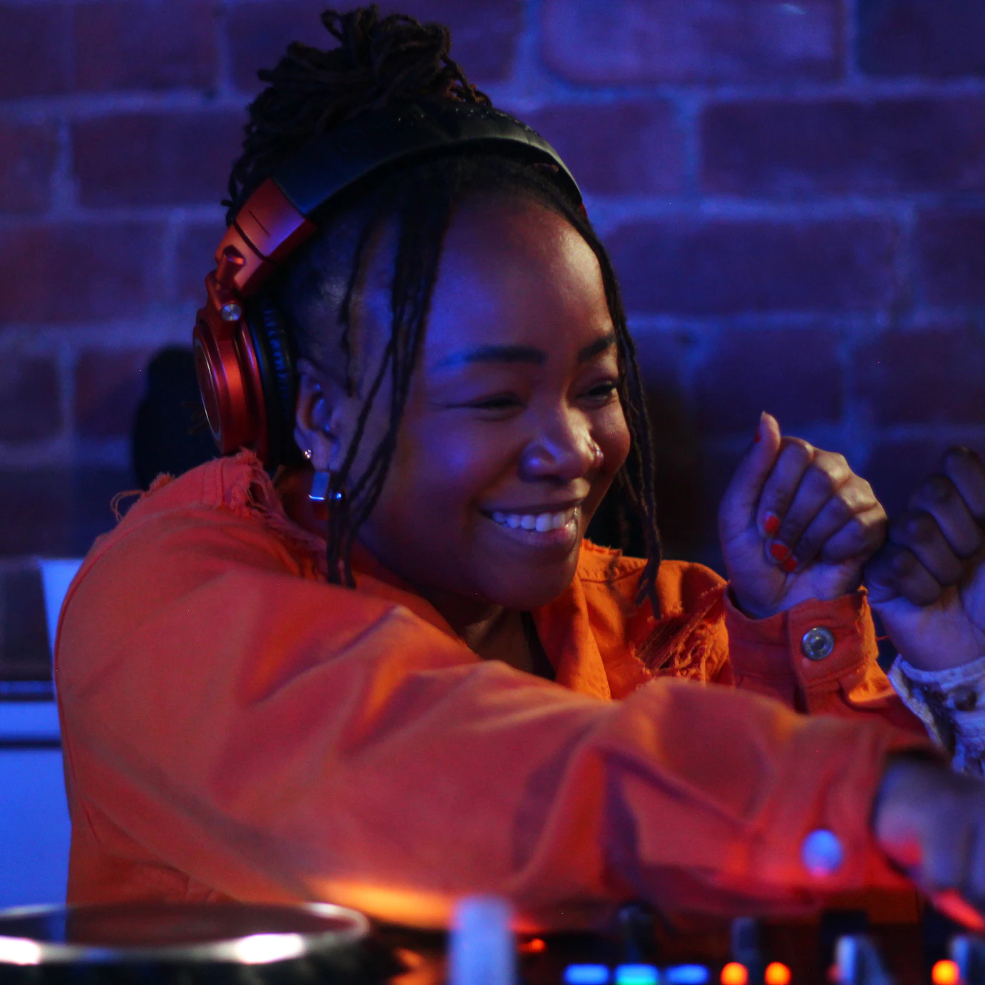 An Afro Energy participant smiling and fist bumping on the decks during the listening party.
